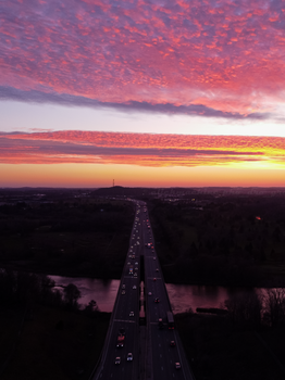 Aerial view of a highway at sunset in Cambridge, Ontario, with vibrant sky