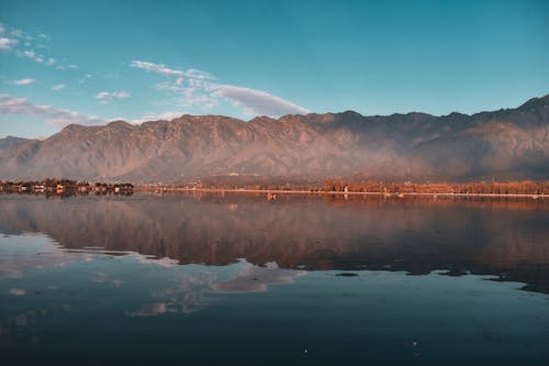 A Lake Near Mountain Under Blue Sky