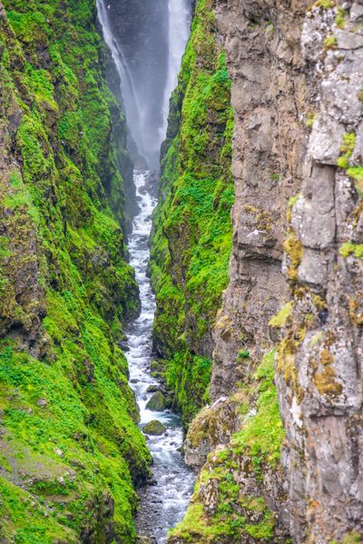 Waterfall rushing through a mossy canyon — Magic K on Pexels