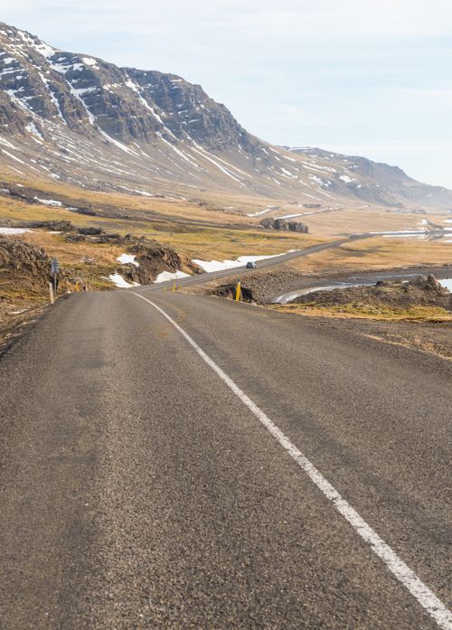 Free A winding road through a dramatic mountainous landscape with clear skies, ideal for travel inspirations. Stock Photo