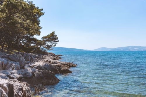 Free Beautiful rocky seashore along the Croatian coastline with crystal clear blue waters. Stock Photo