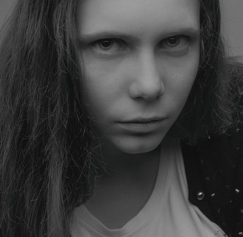 Free Close-up black and white portrait of a woman with an intense expression. Stock Photo