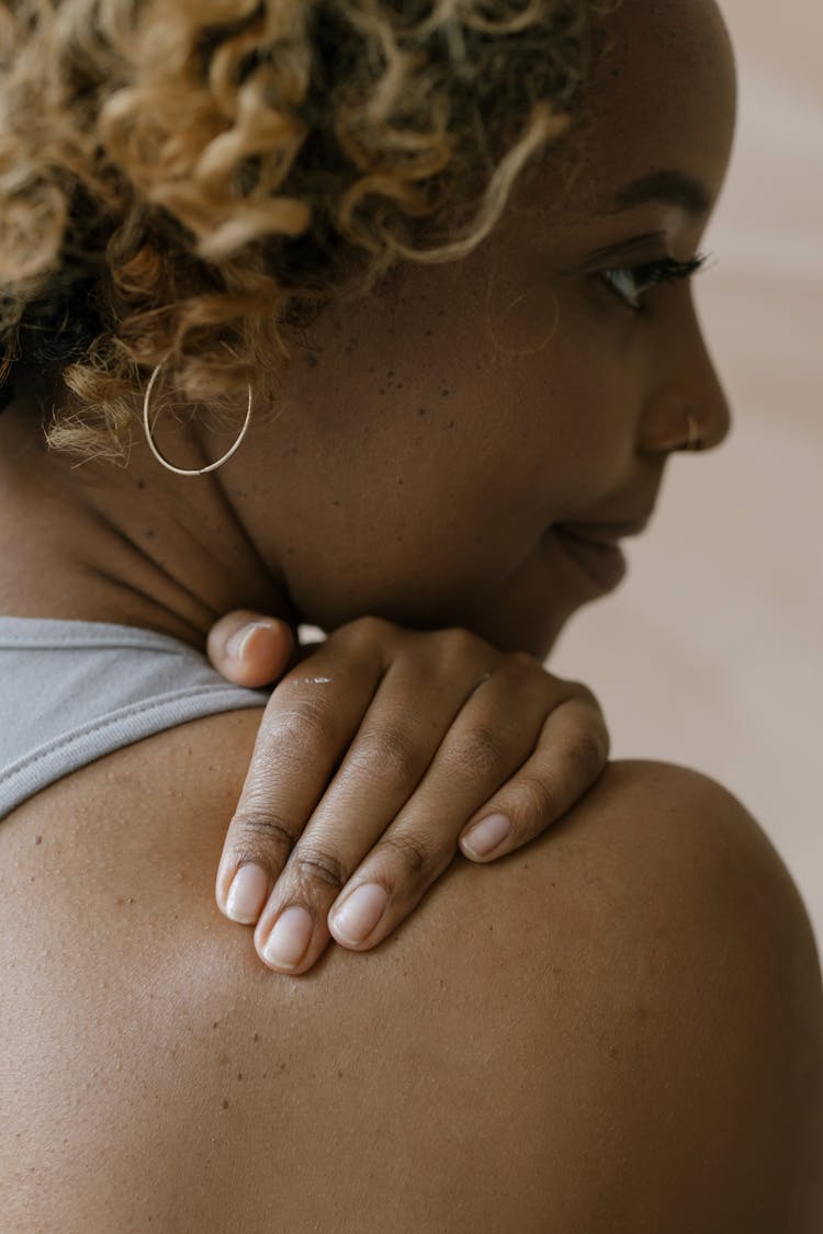 A Woman Touching Her Shoulder