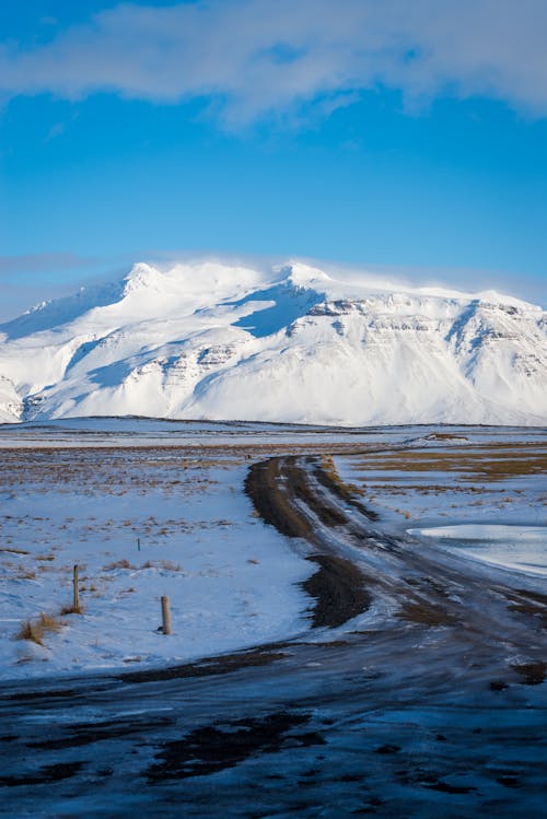 A View of a Snow Covered Mountain under a Blue Sky