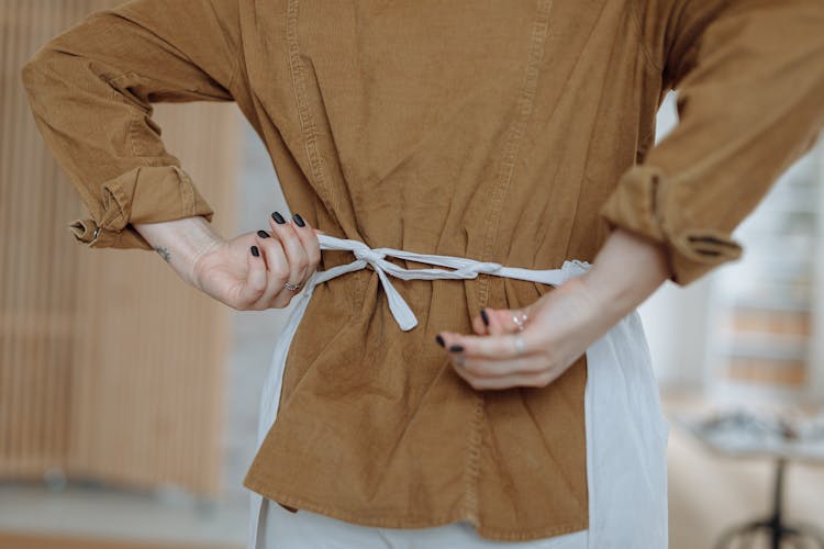 A Woman Tying Her Apron