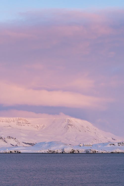 Snow Covered Mountain Under Cloudy Sky