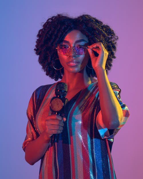 Curly Haired Woman Holding a Microphone 