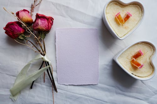 Dried Roses Beside the White Paper 