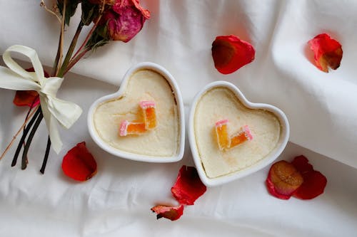 Heart Shaped Ramekins Surrounded by Rose Petals 