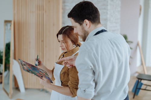 Man Teaching the Woman How to Mix the Paints 