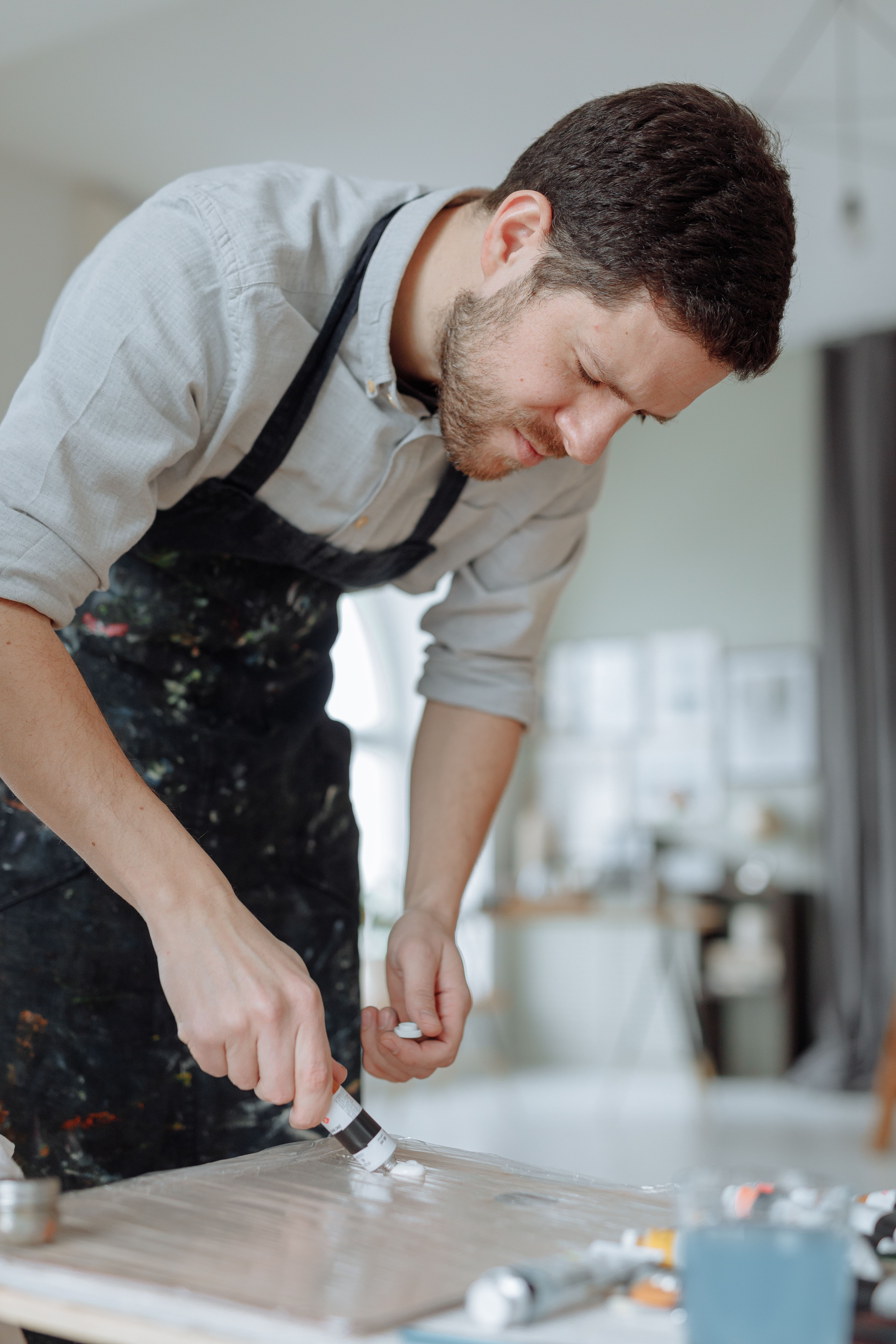 Man Putting White Paint on Painting Palette · Free Stock Photo
