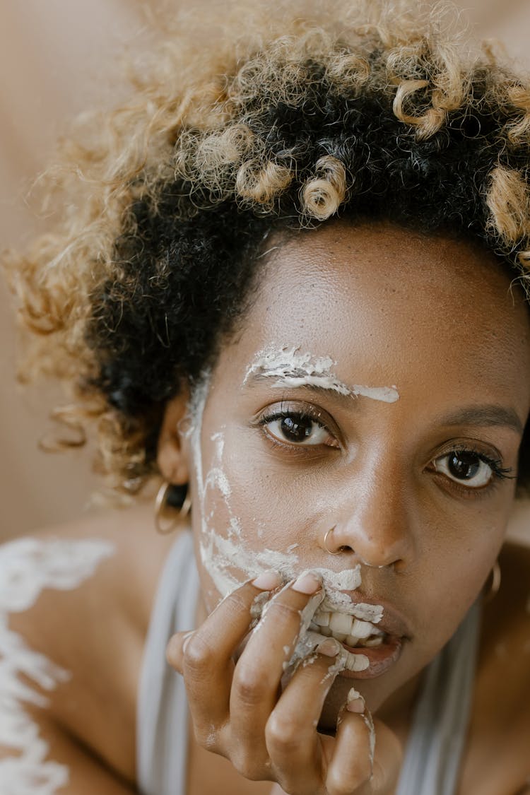 Curly Haired Woman With Mud On Her Face 