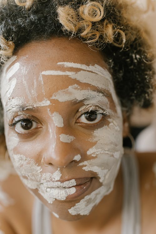 Close-up of Black Woman with White Paint on Face