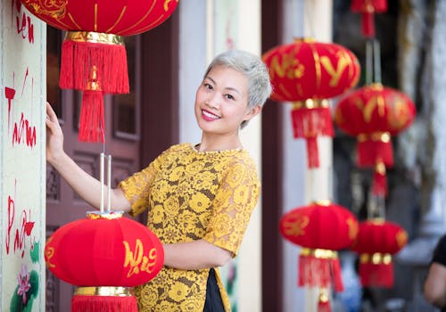 A Woman Standing Near Red Chinese Lanterns