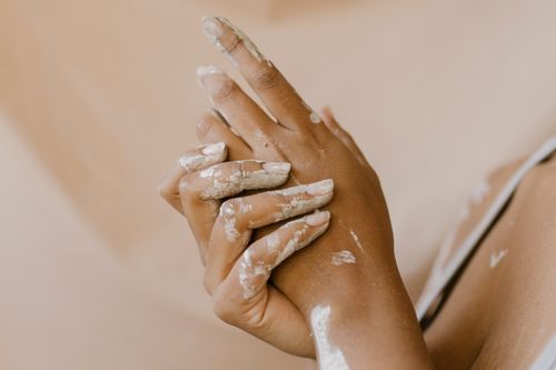 Free Detailed shot of hands with dried clay, symbolizing artistry and craftsmanship. Stock Photo