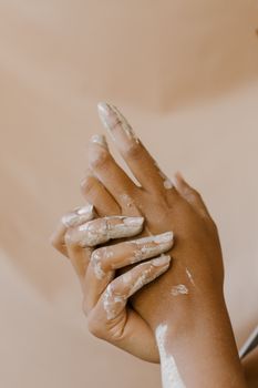 Close-up of hands engaged in artistic clay working, emphasizing the creative process.