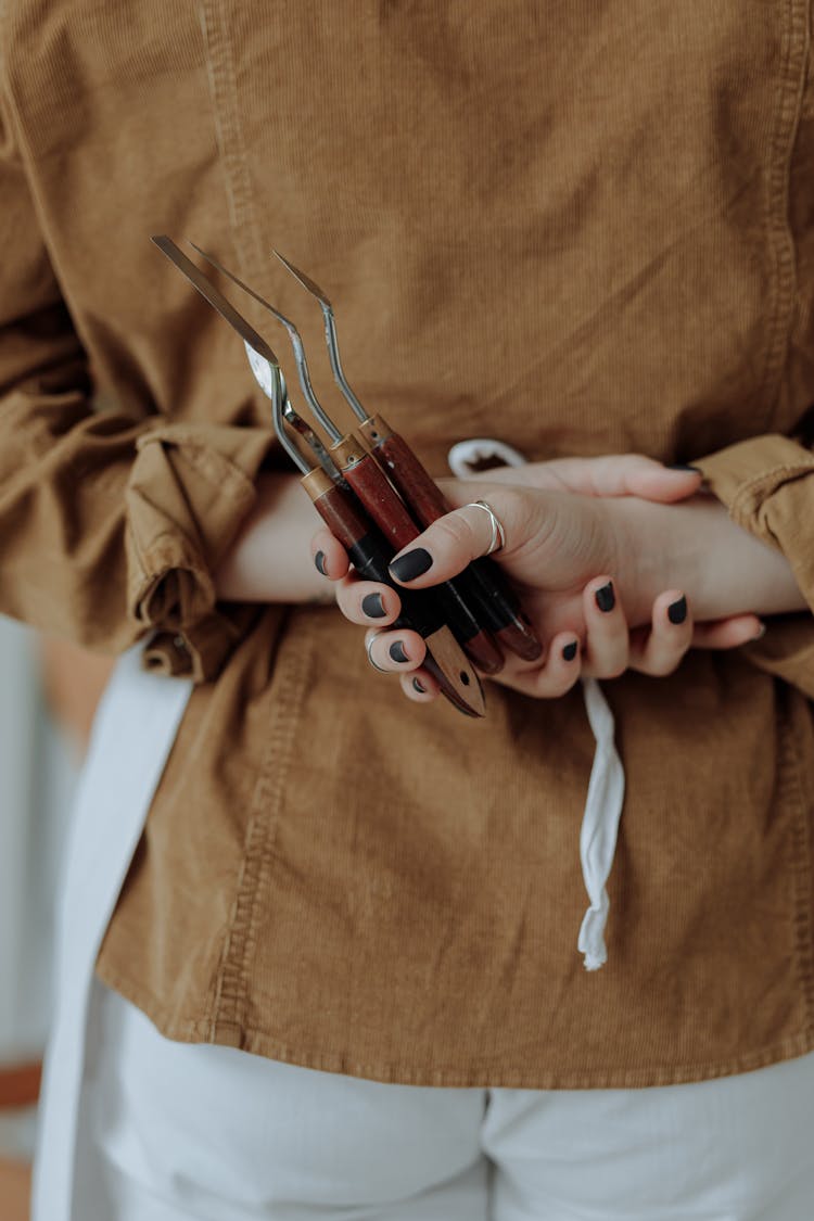 A Person Holding Palette Knives