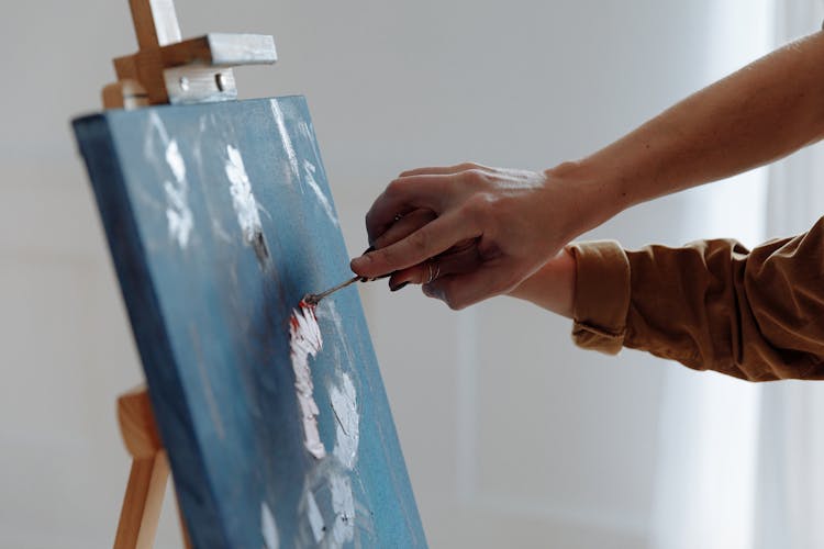 Close-up Photo Of Hands Doing Knife Painting 