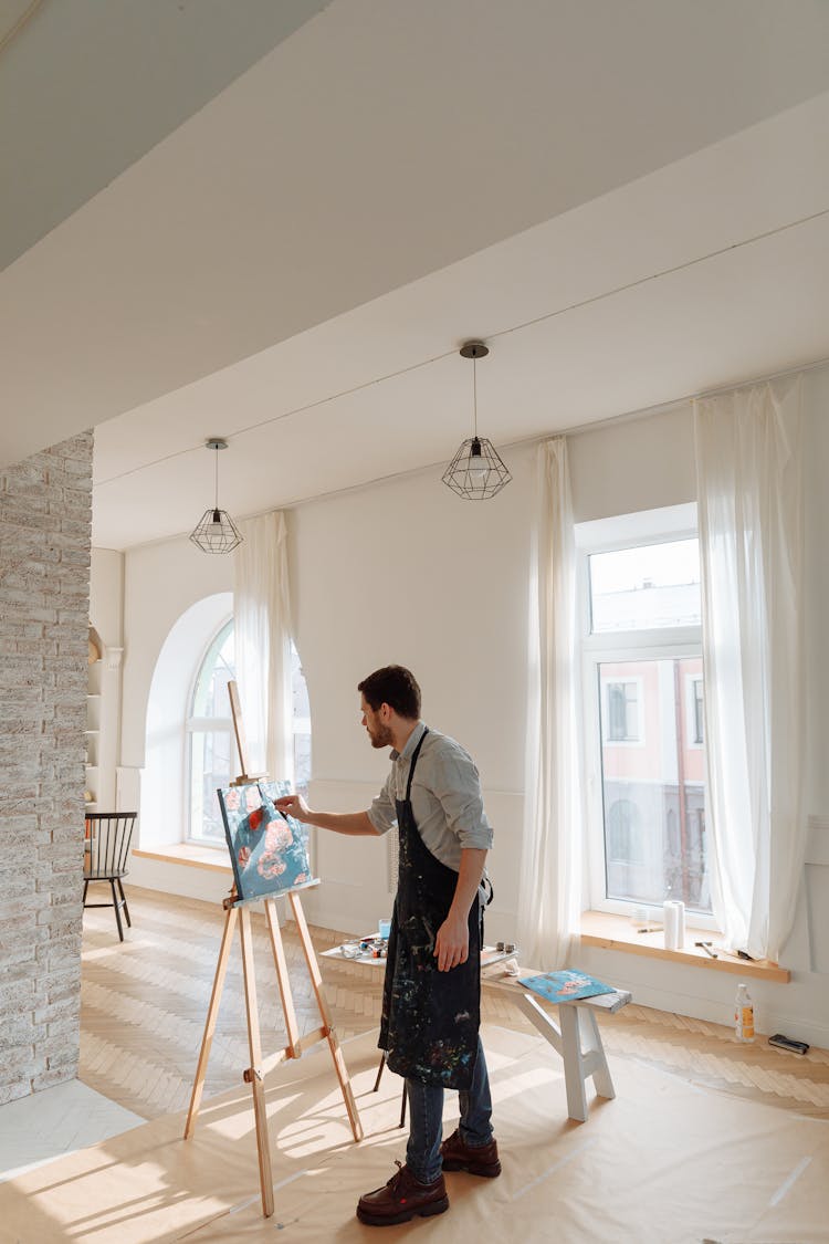 A Man Painting On Canvass