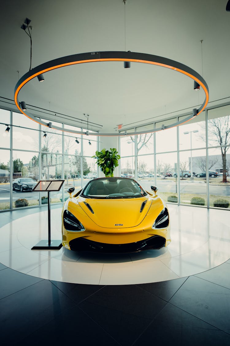 Yellow Luxury Car In Car Dealership Building