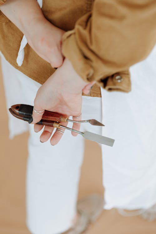 Person Holding Spatulas for Oil Painting