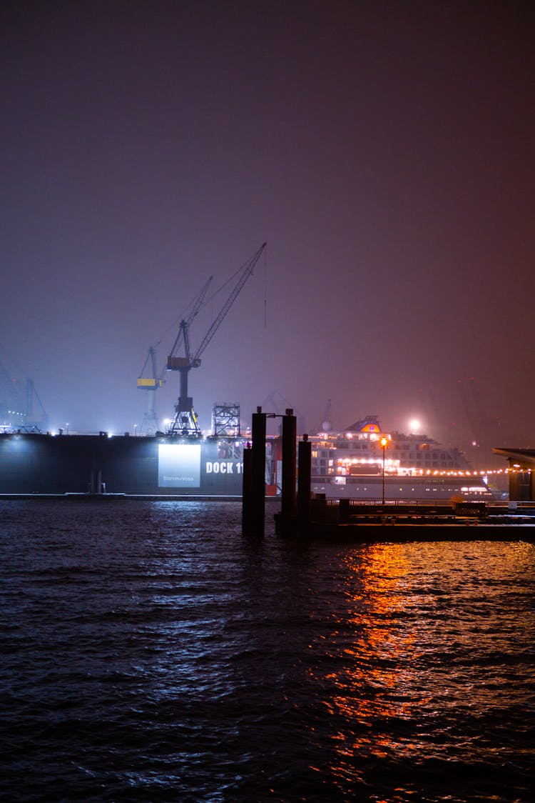 Silhouette Of Ship On The Sea During Night Time