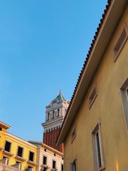 Explore the charm of a European-style clock tower silhouetted against the bright blue sky in Phu Quoc.