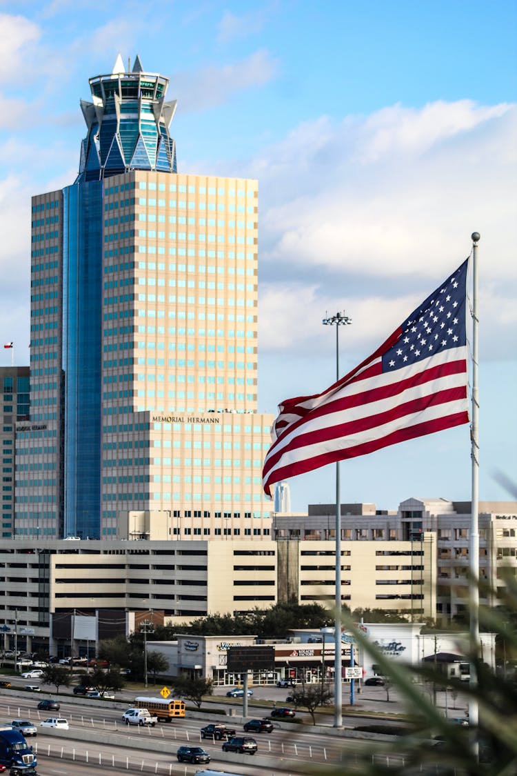 Memorial Hermann Tower And An America Flag 