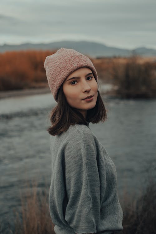 Woman in Gray Sweater Standing on Riverside