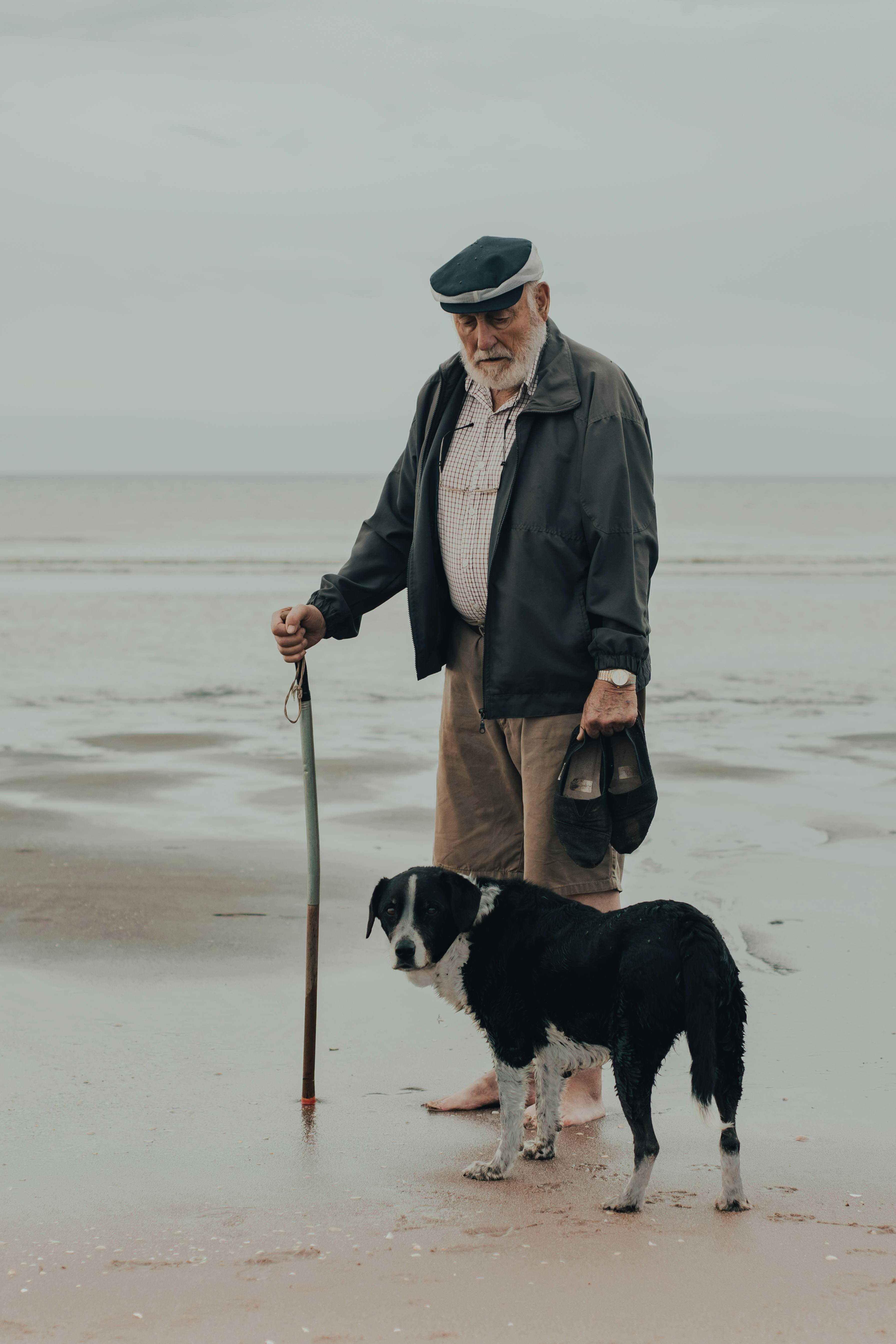 man walking with his dog in the seashore