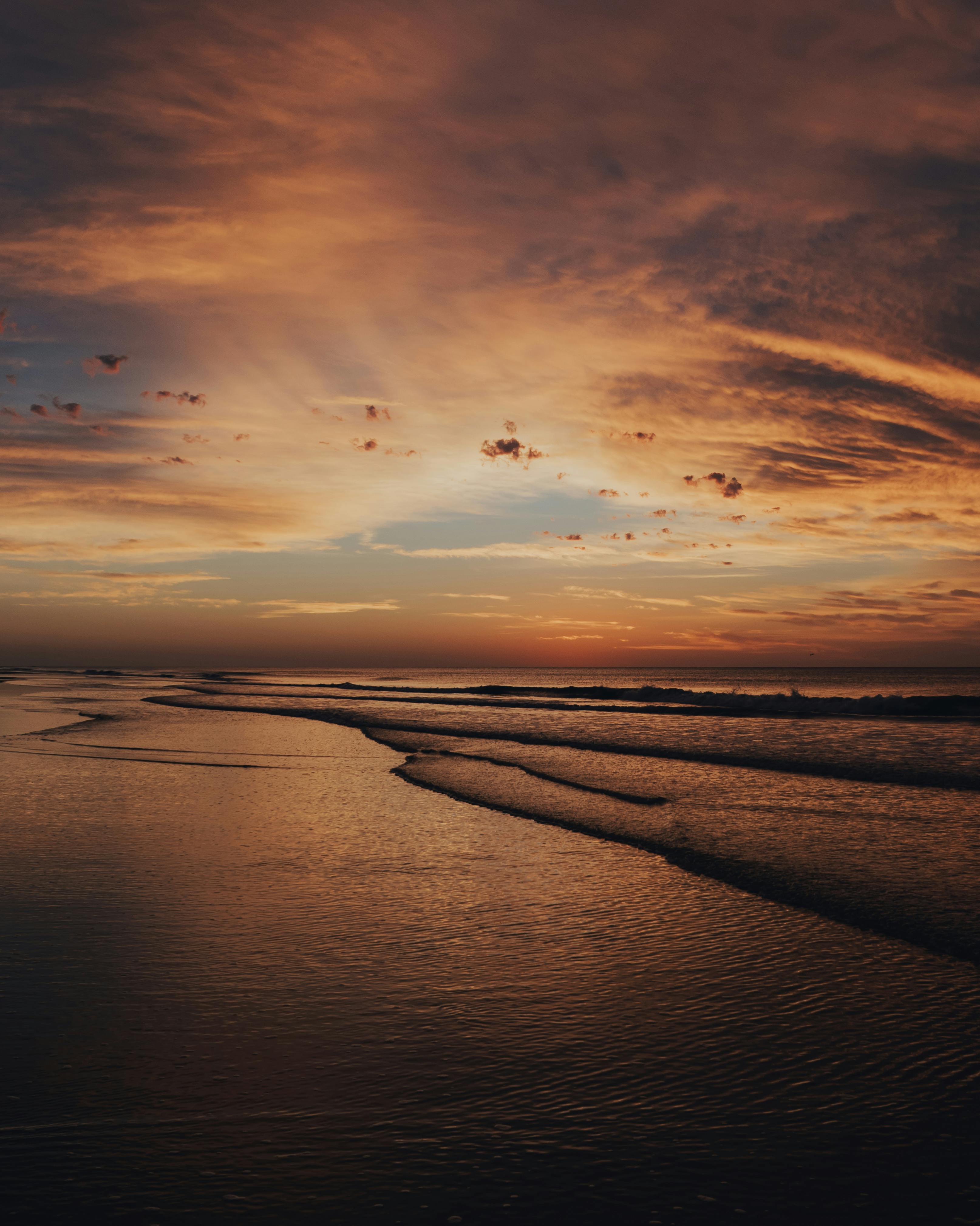 Hays Silhouette Near Ocean during Sunset · Free Stock Photo