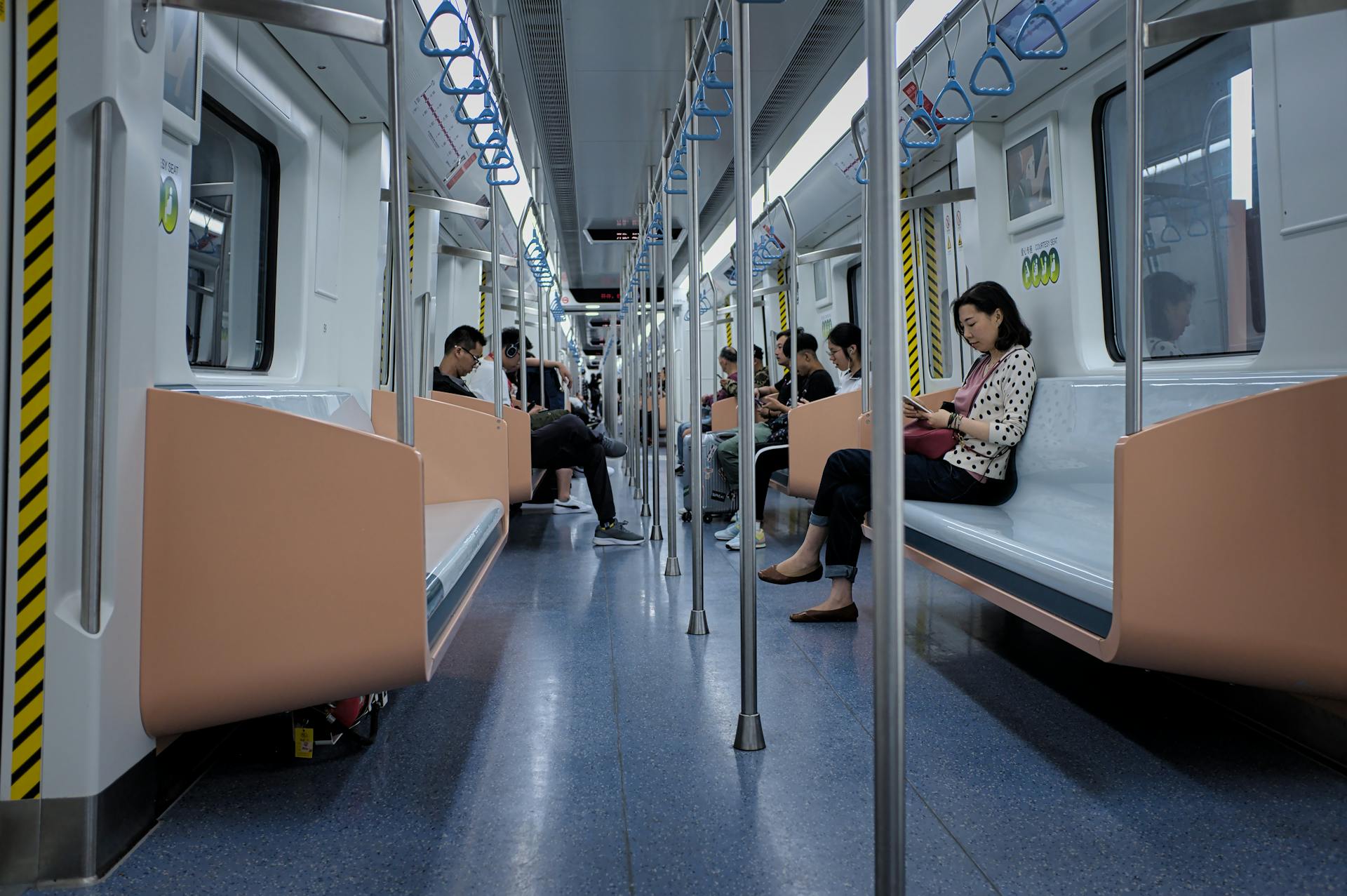 Passengers commute on a Shanghai subway, showcasing a busy city lifestyle.