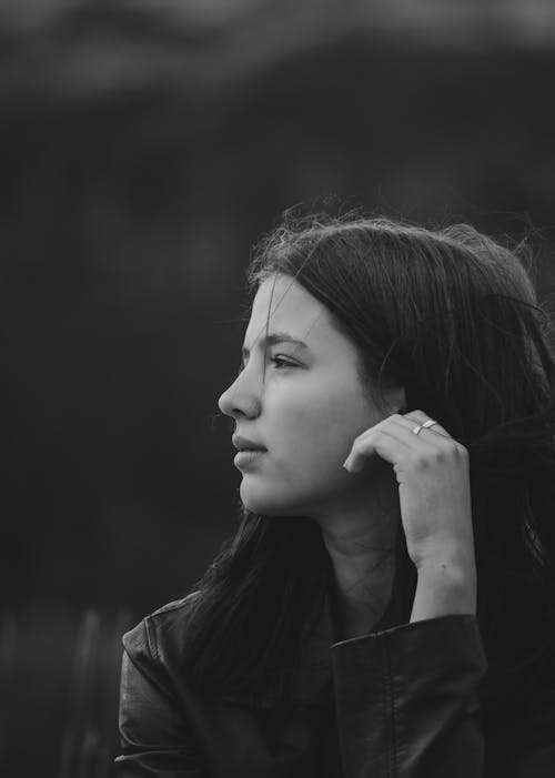 Calm young woman looking away dreamily while admiring nature