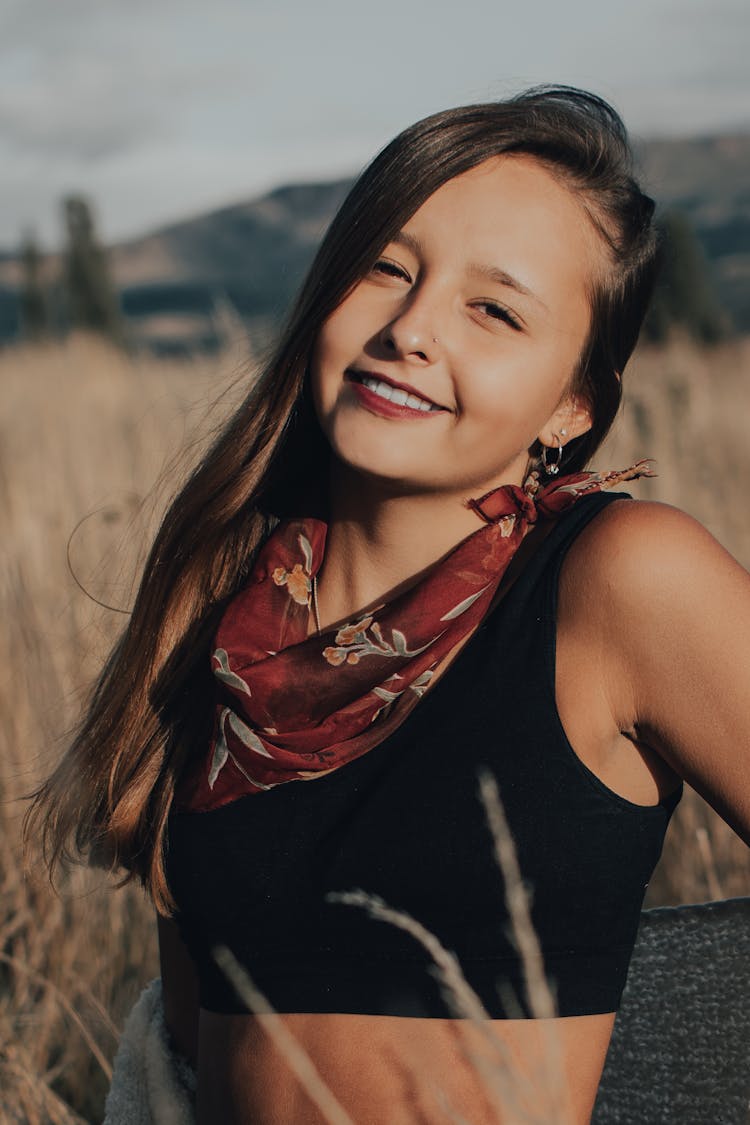 Woman In Black Tank Top And Floral Neck Scarf