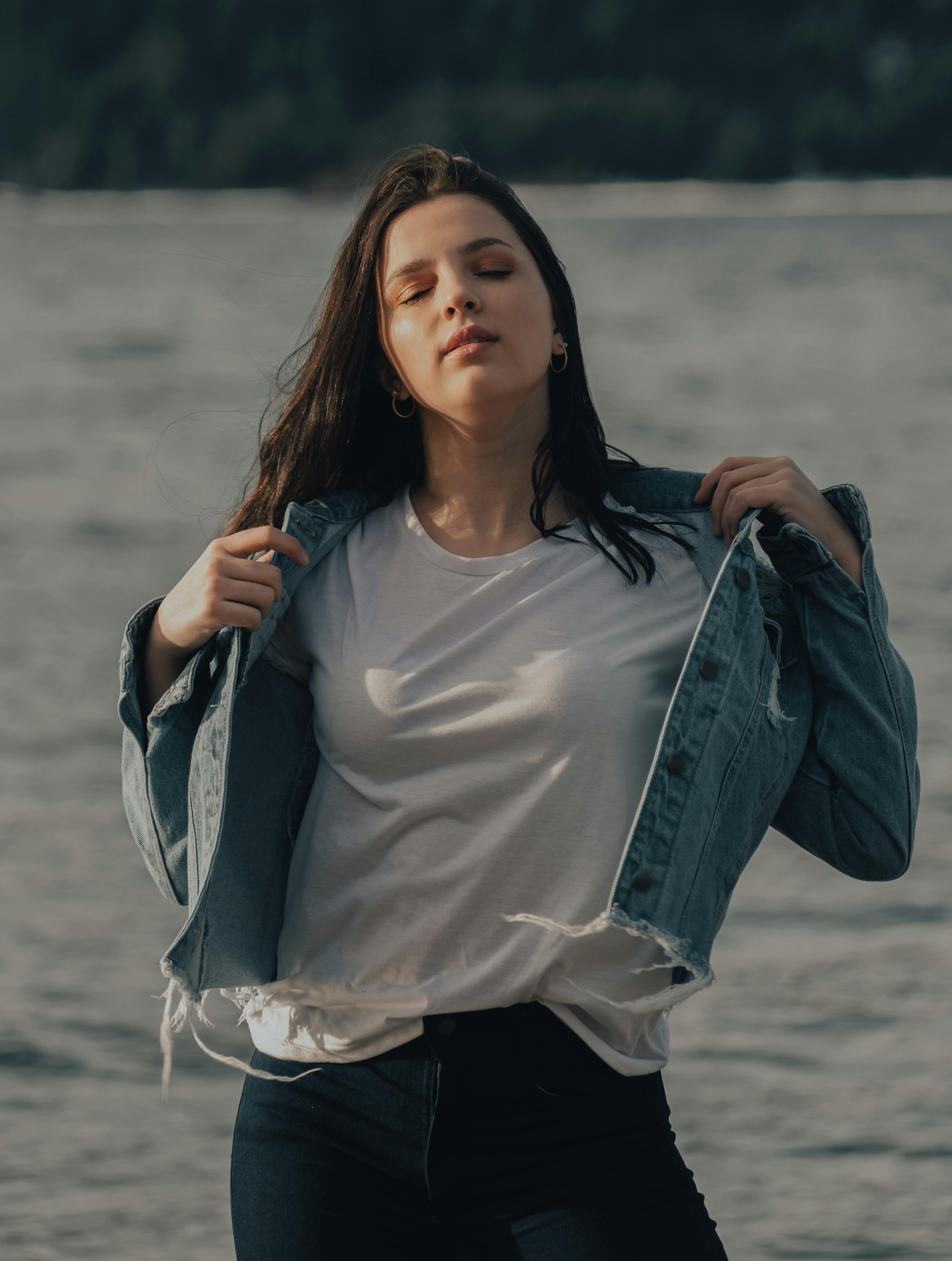 A Woman in White Shirt Under a Blue Denim Jacket · Free Stock Photo