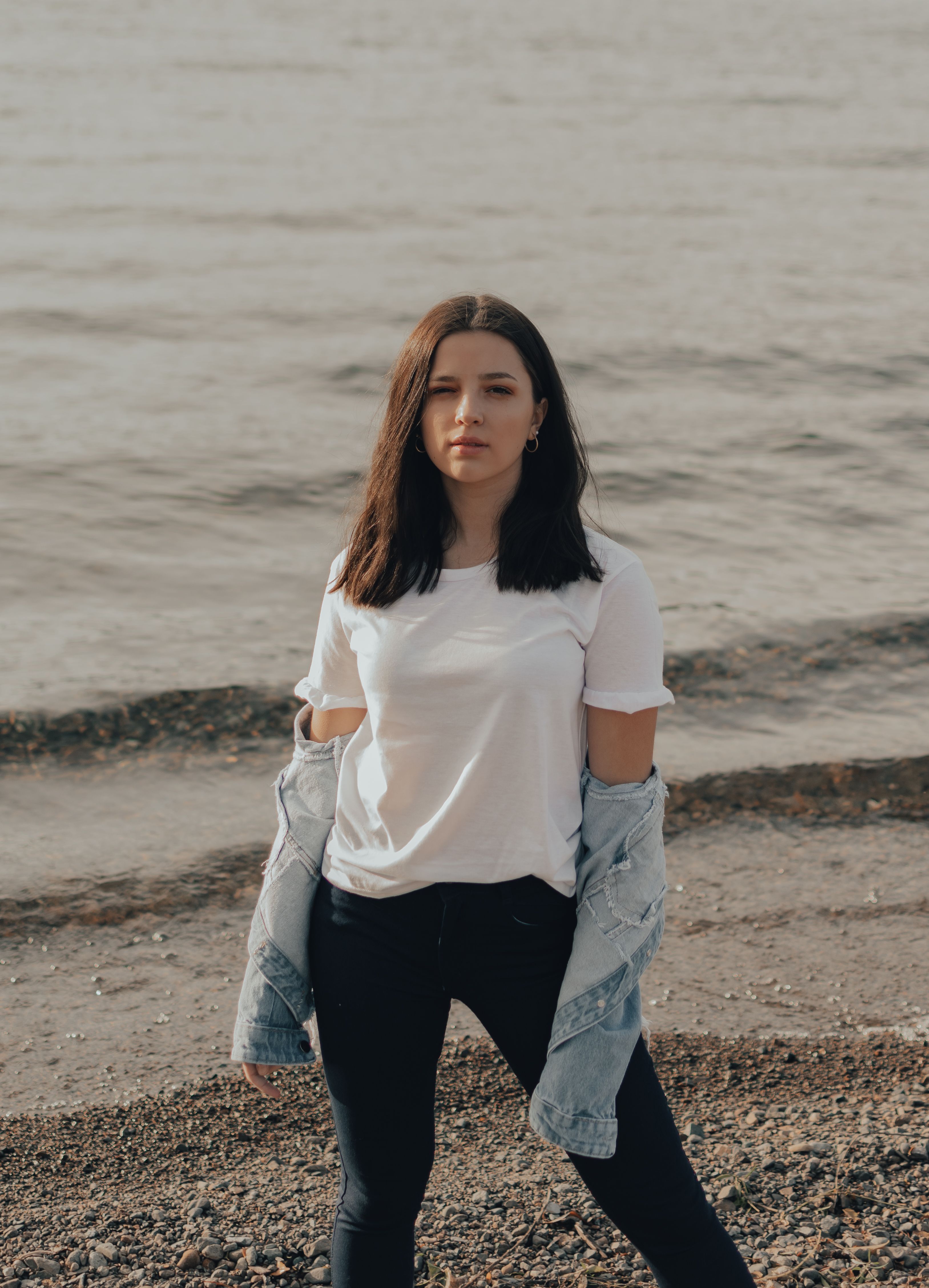 A Woman in White Shirt Standing on Shore · Free Stock Photo