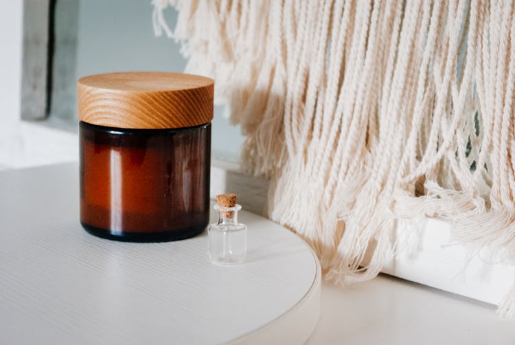 Jar Of Cream And Bottle Of Perfume Placed On Table