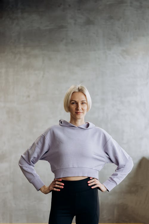 Woman in White Long Sleeve Shirt and Black Leggings