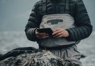 Person in Black Jacket Holding Black Smartphone