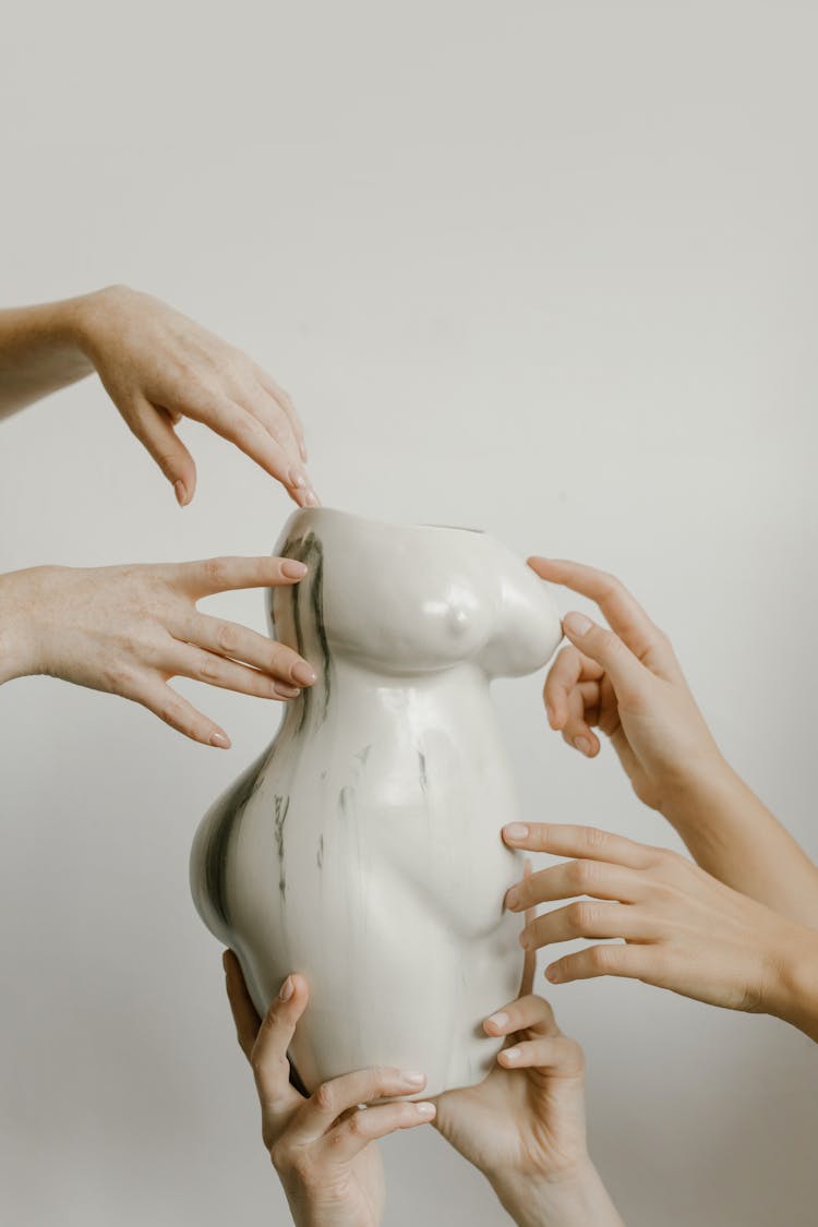 People Holding And Touching A Woman Body Vase 