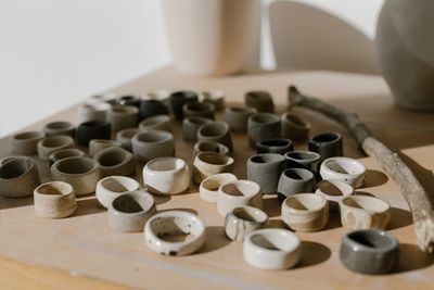 Artisan ceramic rings on a wooden surface, by cottonbro studio on Pexels
