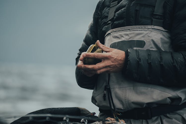 A Person Holding Brown Container