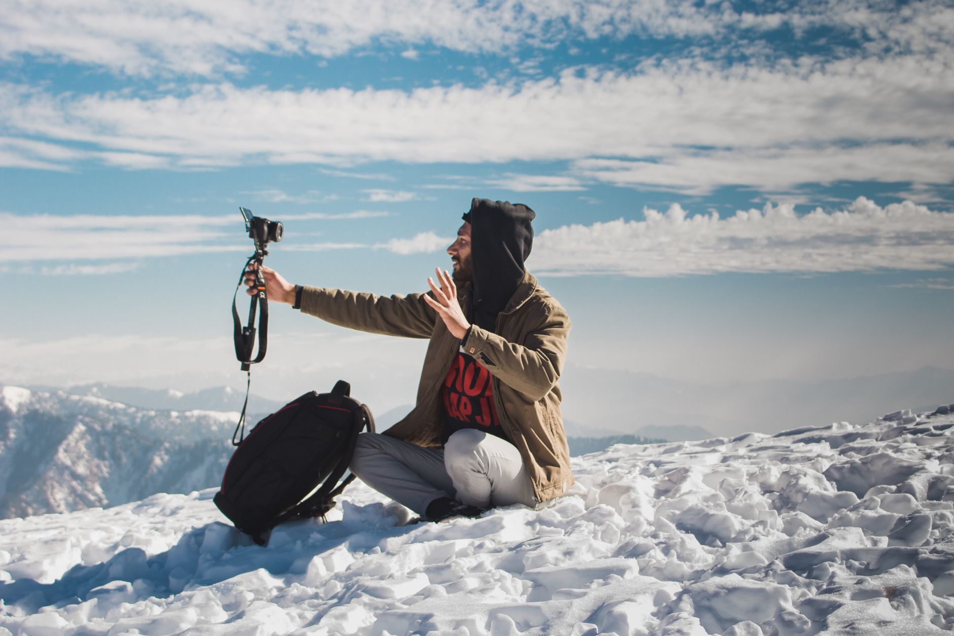A vlogger captures content amidst the snowy peaks of Azad Jammu and Kashmir.