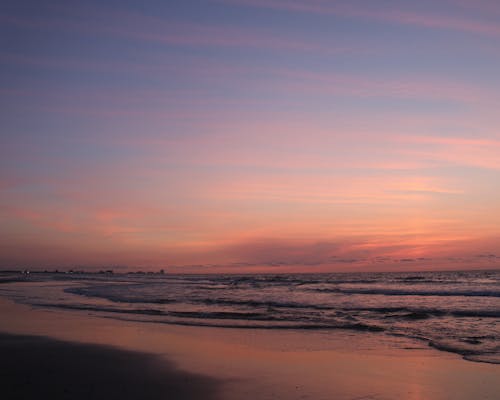 Scenic View of Ocean Waves Crashing on Shore during Dusk 