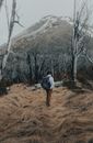 Backpacker standing on Dried Grass