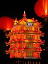 Red Chinese Lanterns and Lighted Pagoda during Night Time