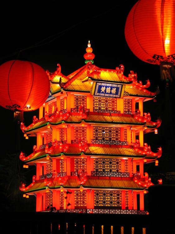 Red Chinese Lanterns and Lighted Pagoda during Night Time