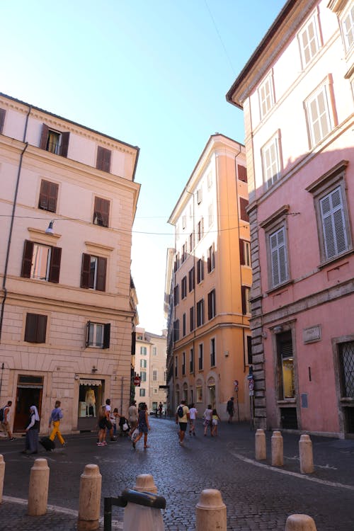 Photo of People Walking on a Street Near Buildings