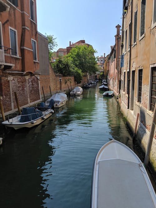 Boat on the Water Between Buildings