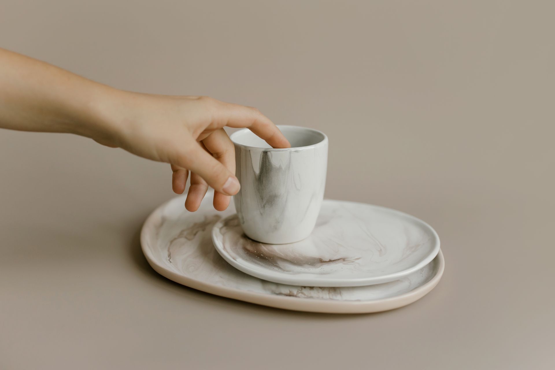 A Person Touching a Ceramic Cup